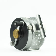 Load image into Gallery viewer, A new farmed fishing reel black and silver mew and unused on a white background 