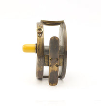 Load image into Gallery viewer, A 1906 rate 4 inch antique brass framed hardy perfect fishing reel  with an ivorine handle shown on a white background with a brass foot 