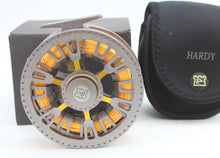 Load image into Gallery viewer, A Hardy Ultralight CA 9000 DD fishing reel with a right-hand configuration, featuring a floating 9 line and a black and orange color scheme with its original case and box