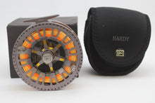 Load image into Gallery viewer, A Hardy Ultralight CA 9000 DD fishing reel with a right-hand configuration, featuring a floating 9 line and a black and orange color scheme with its original case and box