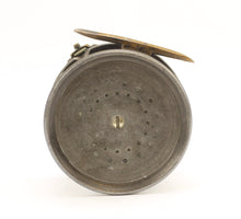 Load image into Gallery viewer, Antique brass faced fishing reel with a center decorative disc and a yellow handle, showing signs of aging and use. 1906 brass faced perfect against a white background
